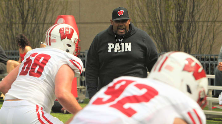 Wisconsin defensive line coach E.J. Whitelow works with Ben Barten (68) and Curt Neal (92) before the team's intrasquad scrimmage on the field north of Camp Randall Stadium in Madison, Wisconsin on Saturday April 27, 2024.