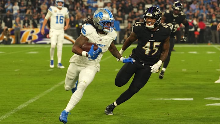 Sep 22, 2025; Baltimore, Maryland, USA; Detroit Lions running back Jahmyr Gibbs (0) rushes the ball past Baltimore Ravens linebacker Mike Green (45) during the first half at M&T Bank Stadium. Mandatory Credit: Mitch Stringer-Imagn Images