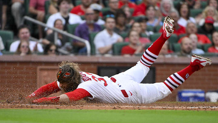 Jun 5, 2025; St. Louis, Missouri, USA;  St. Louis Cardinals second baseman Brendan Donovan (33) slides in head first at home plate to score against the Kansas City Royals during the third inning at Busch Stadium. Mandatory Credit: Jeff Curry-Imagn Images