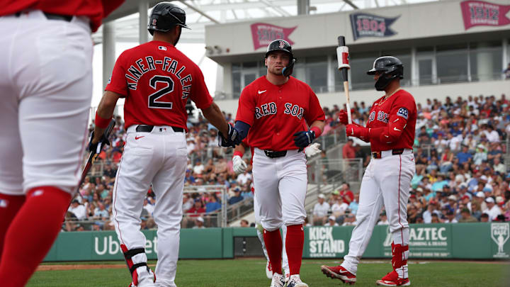 Feb 22, 2026; Fort Myers, Florida, USA;  Boston Red Sox infielder Caleb Durbin (17) is congratulated by infielder Isiah Kiner-Falefa (2) after he scored during the first inning against the Toronto Blue Jays at JetBlue Park at Fenway South. Mandatory Credit: Kim Klement Neitzel-Imagn Images