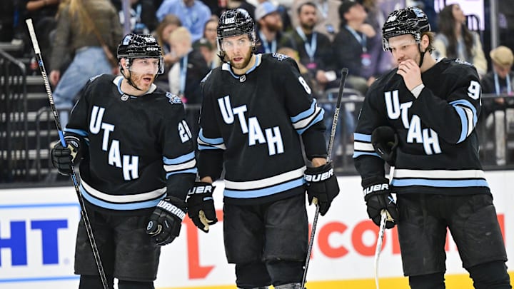 Jan 11, 2025; Salt Lake City, Utah, USA; Utah Hockey Club defenseman Ian Cole (28), center Kevin Stenlund (82), and defenseman Mikhail Sergachev (98) talk before a face-off against the New York Islanders during first period at the Delta Center. Mandatory Credit: Christopher Creveling-Imagn Images