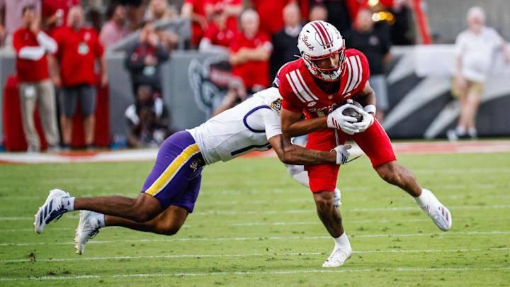 Aug 28, 2025; Raleigh, North Carolina, USA; East Carolina Pirates defensive back Rasheed Reason (17) attempts to tackle North Carolina State Wolfpack wide receiver Teddy Hoffmann (12) during the first half of the game at Carter-Finley Stadium. Mandatory Credit: Jaylynn Nash-Imagn Images Aug 28, 2025; Raleigh, North Carolina, USA; East Carolina Pirates defensive back Rasheed Reason (17) attempts to tackle North Carolina State Wolfpack wide receiver Teddy Hoffmann (12) during the first half of the game at Carter-Finley Stadium. Mandatory Credit: Jaylynn Nash-Imagn Images
