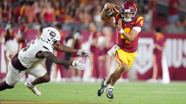 Aug 30, 2025; Los Angeles, California, USA; Southern California Trojans quarterback Husan Longstreet (4) carries the ball against Missouri State Bears cornerback Navonn Barrett (5) in the second half at United Airlines Field at Los Angeles Memorial Coliseum. Mandatory Credit: Kirby Lee-Imagn Images