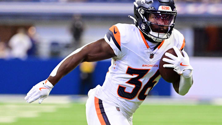 Aug 11, 2024; Indianapolis, Indiana, USA;  Denver Broncos running back Tyler Badie (36) runs the ball during the second half against the Indianapolis Colts at Lucas Oil Stadium. Mandatory Credit: Marc Lebryk-Imagn Images