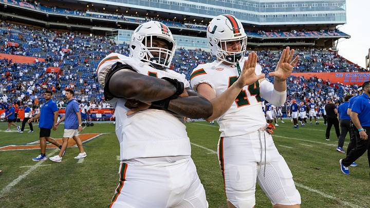 Aug 31, 2024; Gainesville, Florida, USA; Miami Hurricanes defensive lineman Armondo Blount (18) and Miami Hurricanes defensive lineman Cole McConathy II (44) celebrate against the Florida Gators after the game at Ben Hill Griffin Stadium. Mandatory Credit: Matt Pendleton-USA TODAY Sports