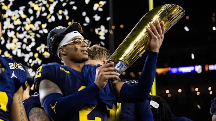 Jan 8, 2024; Houston, TX, USA; Michigan Wolverines defensive back Will Johnson (2) celebrates with the championship trophy after defeating the Washington Huskies during the 2024 College Football Playoff national championship game at NRG Stadium. Mandatory Credit: Mark J. Rebilas-Imagn Images Jan 8, 2024; Houston, TX, USA; Michigan Wolverines defensive back Will Johnson (2) celebrates with the championship trophy after defeating the Washington Huskies during the 2024 College Football Playoff national championship game at NRG Stadium. Mandatory Credit: Mark J. Rebilas-Imagn Images