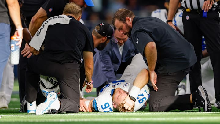 Oct 13, 2024; Arlington, Texas, USA; Detroit Lions defensive end Aidan Hutchinson (97) is injured during a sack against the Dallas Cowboys during the third quarter at AT&T Stadium. Mandatory Credit: Andrew Dieb-Imagn Images Oct 13, 2024; Arlington, Texas, USA; Detroit Lions defensive end Aidan Hutchinson (97) is injured during a sack against the Dallas Cowboys during the third quarter at AT&T Stadium. Mandatory Credit: Andrew Dieb-Imagn Images