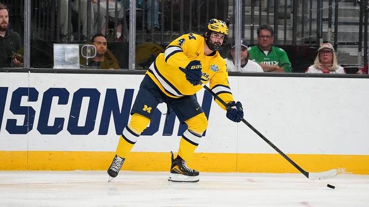 Apr 9, 2026; Las Vegas, Nevada, UNITED STATES; Michigan Wolverines defenseman Asher Barnett (4) passes in overtime against the Denver Pioneers in the semifinals of the NCAA men's ice hockey Frozen Four at T-Mobile Arena. Mandatory Credit: Lucas Peltier-Imagn Images Apr 9, 2026; Las Vegas, Nevada, UNITED STATES; Michigan Wolverines defenseman Asher Barnett (4) passes in overtime against the Denver Pioneers in the semifinals of the NCAA men's ice hockey Frozen Four at T-Mobile Arena. Mandatory Credit: Lucas Peltier-Imagn Images