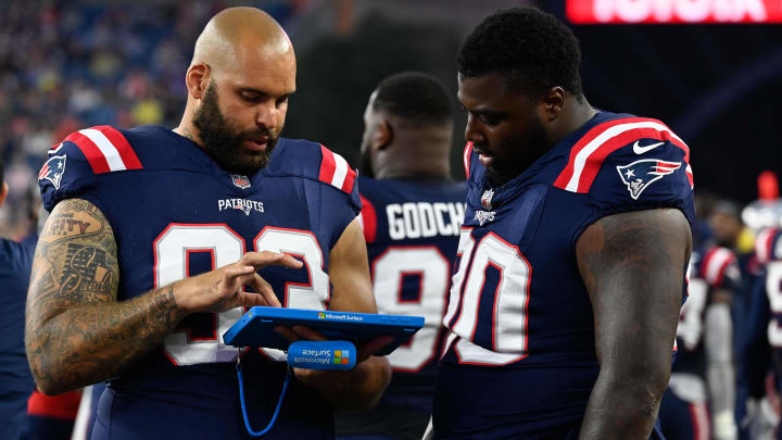 Aug 10, 2023; Foxborough, Massachusetts, USA; New England Patriots defensive end Lawrence Guy Sr. (93) and defensive tackle Christian Barmore (90) review game action during the first half against the Houston Texans at Gillette Stadium. Aug 10, 2023; Foxborough, Massachusetts, USA; New England Patriots defensive end Lawrence Guy Sr. (93) and defensive tackle Christian Barmore (90) review game action during the first half against the Houston Texans at Gillette Stadium.