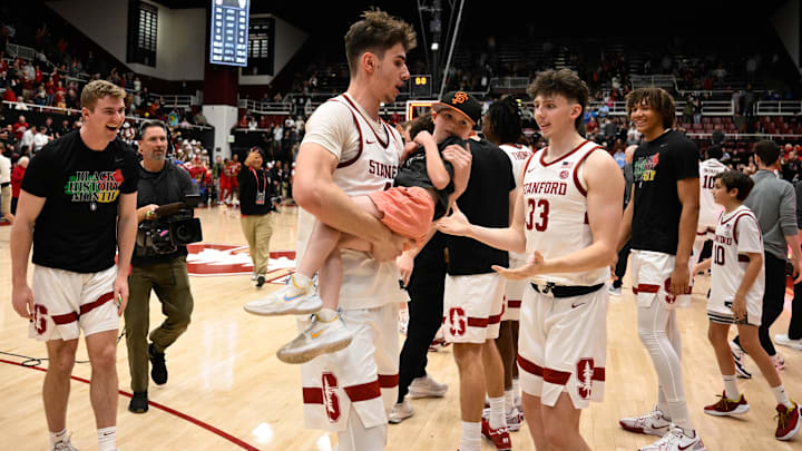 Feb 8, 2025; Stanford, California, USA; Stanford Cardinal forward Maxime Raynaud (42) celebrates with a young fan after their win over the NC State Wolfpack at Maples Pavilion. Mandatory Credit: Eakin Howard-Imagn Images