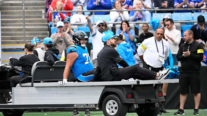 Oct 26, 2025; Charlotte, North Carolina, USA; Carolina Panthers guard Brady Christensen (70) leaves the field on a cart in the fourth quarter against the Buffalo Bills at Bank of America Stadium. Mandatory Credit: Bob Donnan-Imagn Images