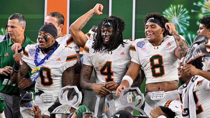 Dec 31, 2025; Arlington, TX, USA; Miami Hurricanes defensive back Keionte Scott (0) and running back Mark Fletcher Jr. (4) and defensive back Jakobe Thomas (8) celebrate after the 2025 Cotton Bowl and quarterfinal game of the College Football Playoff at AT&T Stadium. Mandatory Credit: Jerome Miron-Imagn Images