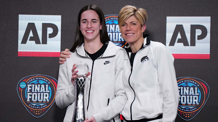 Apr 4, 2024; Cleveland, OH, USA; Iowa Hawkeyes guard Caitlin Clark (left) poses with associate head coach Jan Jensen after being selected as the AP Player of the Year at a press conference at Rocket Mortgage FieldHouse. Mandatory Credit: Kirby Lee-Imagn Images
