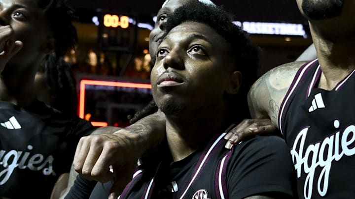 Mar 4, 2025; College Station, Texas, USA; Texas A&M Aggies guard Wade Taylor IV (4) watches with teammates during his retired jersey is revealed after the game against the Auburn Tigers at Reed Arena. Mandatory Credit: Maria Lysaker-Imagn Images Mar 4, 2025; College Station, Texas, USA; Texas A&M Aggies guard Wade Taylor IV (4) watches with teammates during his retired jersey is revealed after the game against the Auburn Tigers at Reed Arena. Mandatory Credit: Maria Lysaker-Imagn Images