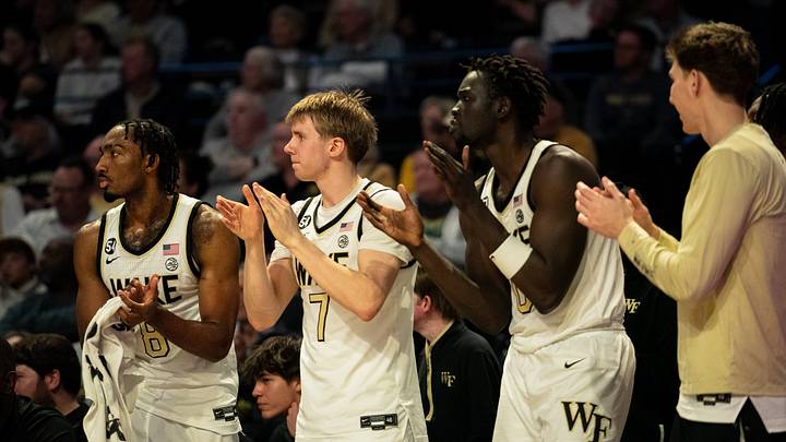Wake Forest Demon Deacons men's basketball players cheer from the sidelines Wake Forest Demon Deacons men's basketball players cheer from the sidelines