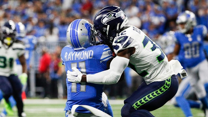 Seattle Seahawks safety Jerrick Reed II (32) tackles punt returner Kalif Raymond (11) during the first half at Ford Field in Detroit on Sunday, Sept. 17, 2023.