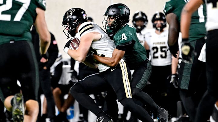 Michigan State's Ed Woods, right, tackles Purdue's Drew Biber during the first quarter on Friday, Nov. 22, 2024, at Spartan Stadium in East Lansing.