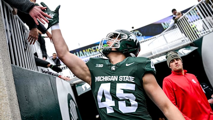 Michigan State's Brady Pretzlaff slaps hands with fans during the Spring Showcase on Saturday, April 20, 2024, at Spartan Stadium in East Lansing.