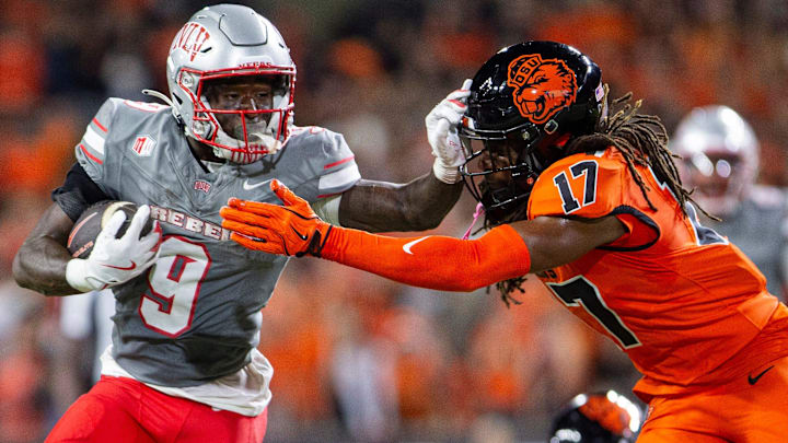 UNLV Rebels running back Jai'Den Thomas (9) stiff arms Oregon State Beavers defensive back Skyler Thomas (17) during an NCAA football game against UNLV at Reser Stadium UNLV Rebels running back Jai'Den Thomas (9) stiff arms Oregon State Beavers defensive back Skyler Thomas (17) during an NCAA football game against UNLV at Reser Stadium