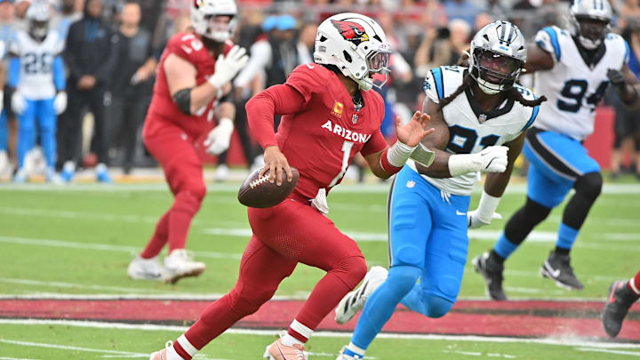 Sep 14, 2025; Glendale, Arizona, USA; Arizona Cardinals quarterback Kyler Murray (1) runs the ball during the first quarter against Carolina Panthers linebacker Patrick Jones II (91) at State Farm Stadium. 