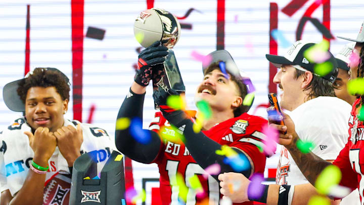 Texas Tech Red Raiders linebacker Jacob Rodriguez celebrates with the Big 12 Championship trophy after the win over BYU 
