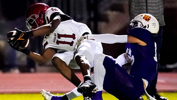 Brentwood Academy's Kesean Bowman (11) is pulled down by Father Ryan's Catlin Hagan (15) during the first quarter at Father Ryan High School in Nashville, Tenn., Friday, Nov. 15, 2024. Brentwood Academy's Kesean Bowman (11) is pulled down by Father Ryan's Catlin Hagan (15) during the first quarter at Father Ryan High School in Nashville, Tenn., Friday, Nov. 15, 2024.