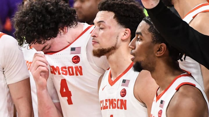 Clemson senior forward Ian Schieffelin (4), left, Clemson guard Hunter (1) and guard Dillon Hunter (2) during the alma mater song after losing the game to Georgia Tech 89-86 at Littlejohn Coliseum in Clemson, S.C. Tuesday, February 4, 2025.