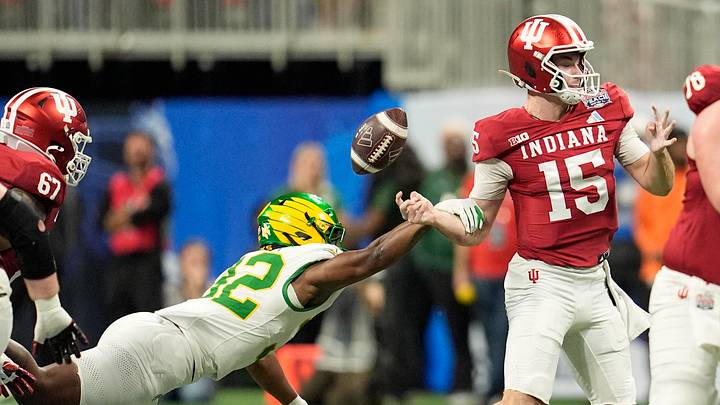 Jan 9, 2026; Atlanta, GA, USA; Oregon Ducks linebacker Nasir Wyatt (32) forces a fumble by Indiana Hoosiers quarterback Fernando Mendoza (15) during the first half of the 2025 Peach Bowl and semifinal game of the College Football Playoff at Mercedes-Benz Stadium. Indiana Hoosiers recovered the fumble on the play. Mandatory Credit: Dale Zanine-Imagn Images