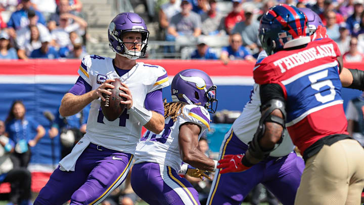 Sep 8, 2024; East Rutherford, New Jersey, USA; Minnesota Vikings quarterback Sam Darnold (14) drops back to pass during the first quarter against the New York Giants at MetLife Stadium. Mandatory Credit: Vincent Carchietta-Imagn Images