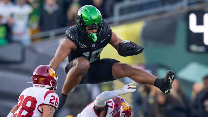 Oregon tight end Kenyon Sadiq hurdles over USC cornerback DeCarlos Nicholson as the Oregon Ducks host the USC Trojans on Nov. 22, 2025, at Autzen Stadium in Eugene, Oregon.