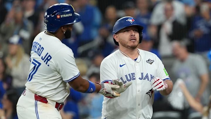 Oct 24, 2025; Toronto, Ontario, CAN; Toronto Blue Jays catcher Alejandro Kirk (30) celebrates with first baseman Vladimir Guerrero Jr. (27) after hitting a two run home run against the Los Angeles Dodgers in the sixth inning during game one of the 2025 MLB World Series at Rogers Centre. 