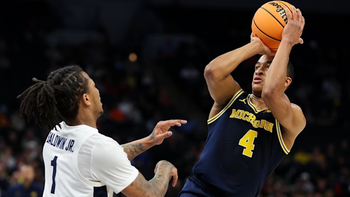 Mar 13, 2024; Minneapolis, MN, USA; Michigan Wolverines guard Nimari Burnett (4) shoots as Penn State Nittany Lions guard Ace Baldwin Jr. (1) defends during the first half at Target Center. Mandatory Credit: Matt Krohn-Imagn Images Mar 13, 2024; Minneapolis, MN, USA; Michigan Wolverines guard Nimari Burnett (4) shoots as Penn State Nittany Lions guard Ace Baldwin Jr. (1) defends during the first half at Target Center. Mandatory Credit: Matt Krohn-Imagn Images