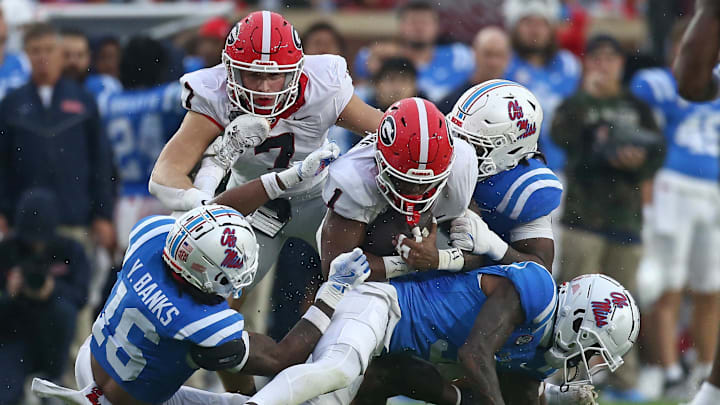 Nov 9, 2024; Oxford, Mississippi, USA; Georgia Bulldogs running back Trevor Etienne (1) runs the ball as Mississippi Rebels defensive back Trey Amos (9) makes the tackle during the first half at Vaught-Hemingway Stadium. Mandatory Credit: Petre Thomas-Imagn Images