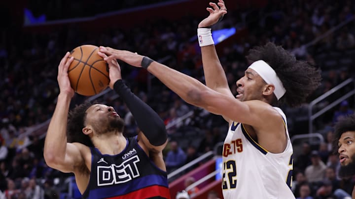 Nov 20, 2023; Detroit, Michigan, USA;  Denver Nuggets forward Zeke Nnaji (22) blocks a shot by Detroit Pistons guard Cade Cunningham (2) in the second half at Little Caesars Arena. Mandatory Credit: Rick Osentoski-Imagn Images