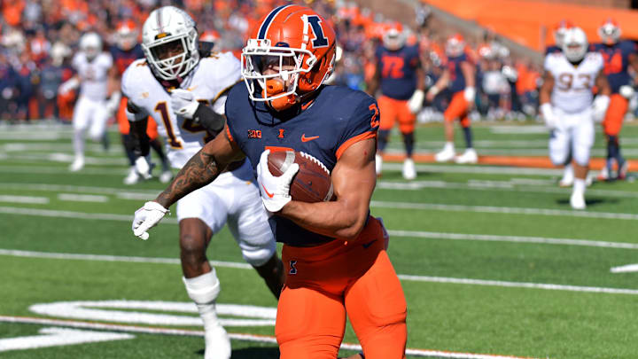 Oct 15, 2022; Champaign, Illinois, USA;  Illinois Fighting Illini running back Chase Brown (2) scores a touchdown during the first half against the Minnesota Golden Gophers at Memorial Stadium. Mandatory Credit: Ron Johnson-Imagn Images