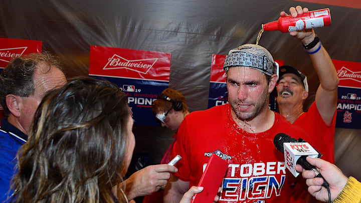 Sep 29, 2019; St. Louis, MO, USA; St. Louis Cardinals first baseman Paul Goldschmidt (46) talks with reporters as pitching coach Mike Maddux (31) pours beer on him after the Cardinals clinched the National League Central Division with a 9-0 win against the Chicago Cubs at Busch Stadium. Mandatory Credit: Jeff Curry-Imagn Images