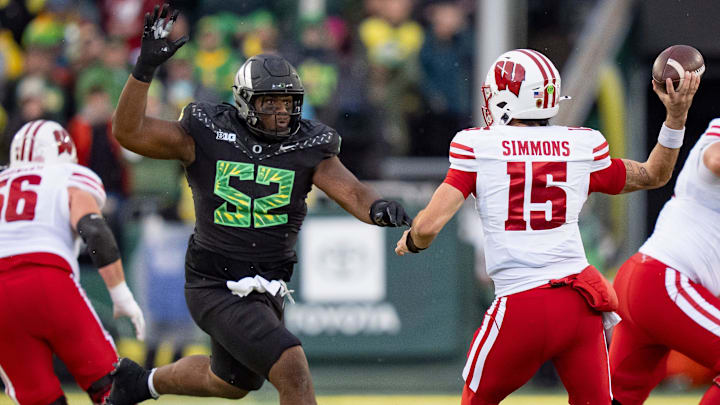 Oregon's defensive tackle A'Mauri Washington pressures Wisconsin quarterback Hunter Simmons earlier this season. Oregon's defensive tackle A'Mauri Washington pressures Wisconsin quarterback Hunter Simmons earlier this season.