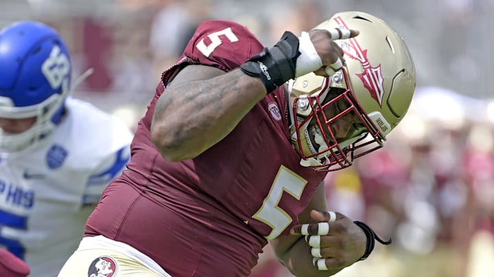 Sep 14, 2024; Tallahassee, Florida, USA; Florida State Seminoles defensive lineman Joshua Farmer (5) celebrates after a defensive stop against the Memphis Tigers during the first half at Doak S. Campbell Stadium. Mandatory Credit: Melina Myers-Imagn Images