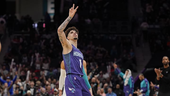Mar 20, 2025; Charlotte, North Carolina, USA; Charlotte Hornets guard LaMelo Ball (1) signals for his three point shot against the New York Knicks during the second half at Spectrum Center. Mandatory Credit: Jim Dedmon-Imagn Images