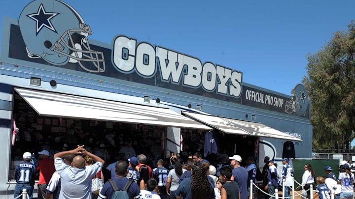 Fans purchase merchandise at the Dallas Cowboys mobile pro shop at training camp at River Ridge Field. 