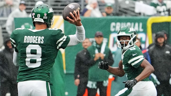 Sep 29, 2024; East Rutherford, New Jersey, USA;  New York Jets quarterback Aaron Rodgers (8) throws complete pass to wide receiver Garrett Wilson (5) against the Denver Broncos in the second half at MetLife Stadium.