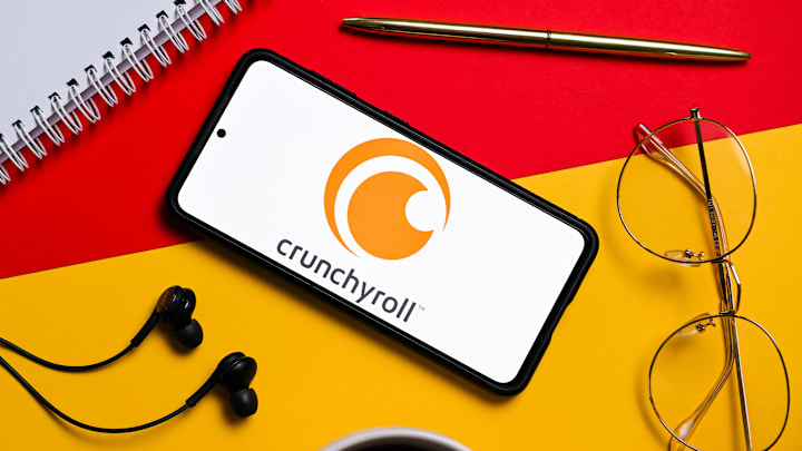 In this photo illustration a Crunchyroll logo seen displayed...