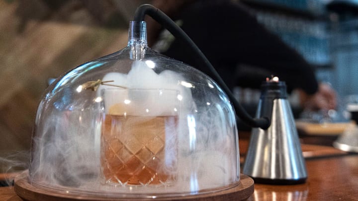 Tasting room director Katrina Hayes prepares their bestseller drink Smoked OG Old Fashioned with