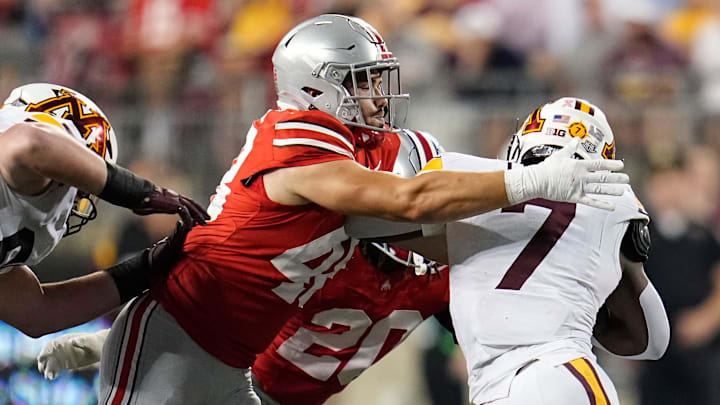 Ohio State defensive lineman Logan George (48) tackles Minnesota running back Fame Ijeboi. Ohio State defensive lineman Logan George (48) tackles Minnesota running back Fame Ijeboi.