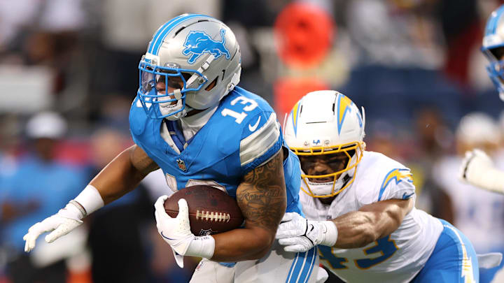 Jul 31, 2025; Canton, Ohio, USA; Los Angeles Chargers linebacker Troy Dye (43) tackles Detroit Lions running back Craig Reynolds (13) in the first quarter at Tom Benson Hall of Fame Stadium. Mandatory Credit: Scott Galvin-Imagn Images