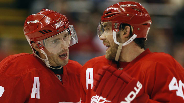 Pavel Datsyuk (left) and Henrik Zetterberg talk during play.