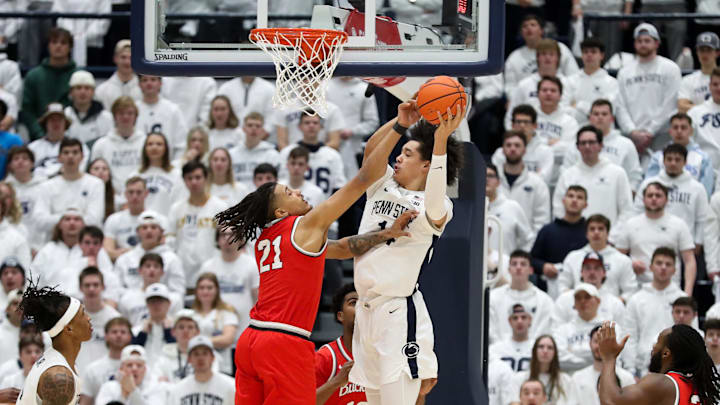 Penn State Nittany Lions forward Yanic Konan Niederhauser (14) grabs the rebound as Ohio State Buckeyes forward Devin Royal (21) defends during the first half at Rec Hall.