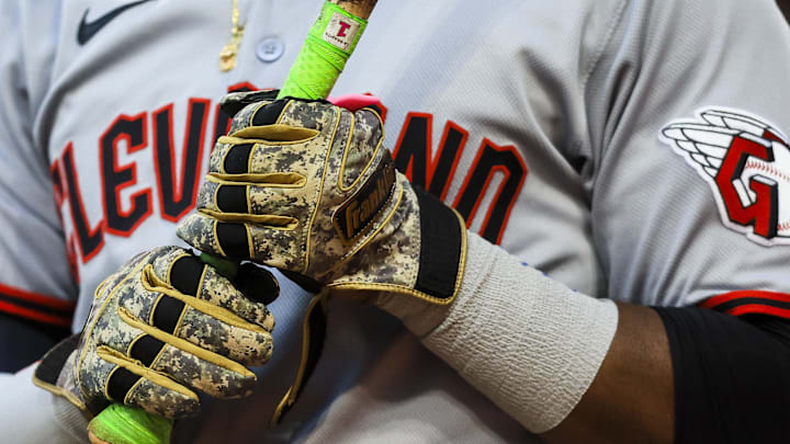 May 17, 2025; Cincinnati, Ohio, USA; A detail view of the gloves of Cleveland Guardians outfielder Angel Martinez (1) as he prepares on deck in the seventh inning against the Cincinnati Reds at Great American Ball Park. Mandatory Credit: Katie Stratman-Imagn Images