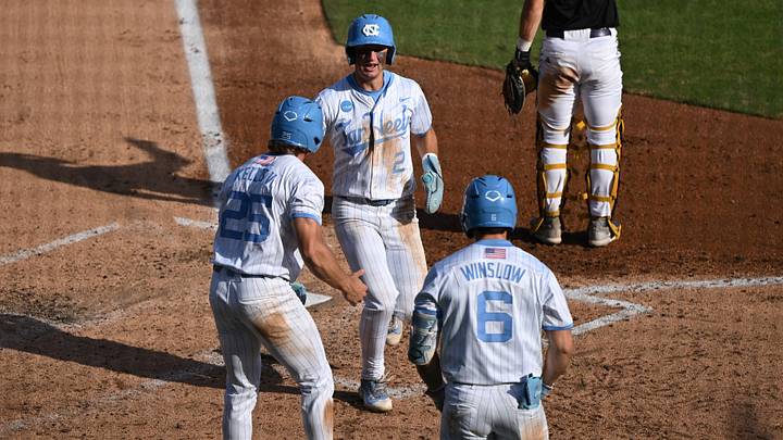 May 31, 2026; Chapel Hill, NC, USA; North Carolina Tar Heels infielder Jake Schaffner (2) is greeted at the plate after scoring by outfielder Rom Kellis (25) and catcher MacOn Winslow (6) against the East Carolina Pirates during the Chapel Hill Regional at Boshamer Stadium. Mandatory Credit: William Howard-Imagn Images