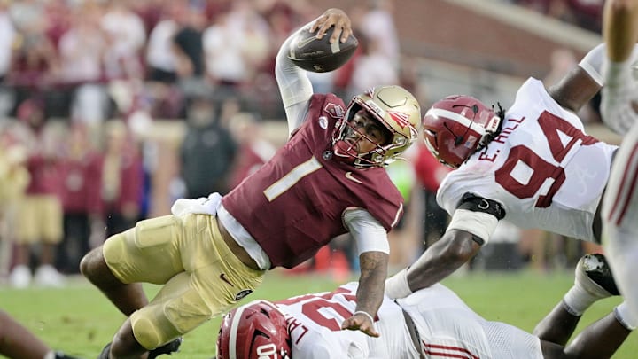 Aug 30, 2025; Tallahassee, Florida, USA; Florida State Seminoles quarterback Tommy Castellanos (1) loses his footing against Alabama Crimson Tide linebacker Jah-Marien Latham (20) during the second half at Doak S. Campbell Stadium. Mandatory Credit: Melina Myers-Imagn Images